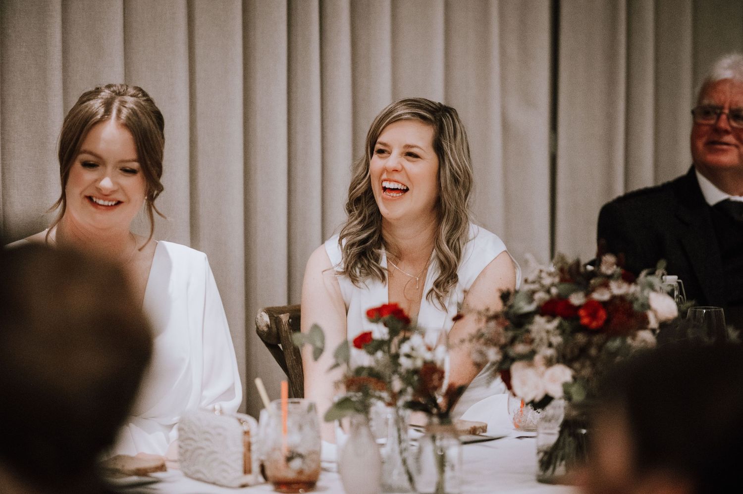 Same Sex Wedding Photography. Joyful celebration moments captured during an indoor wedding reception.