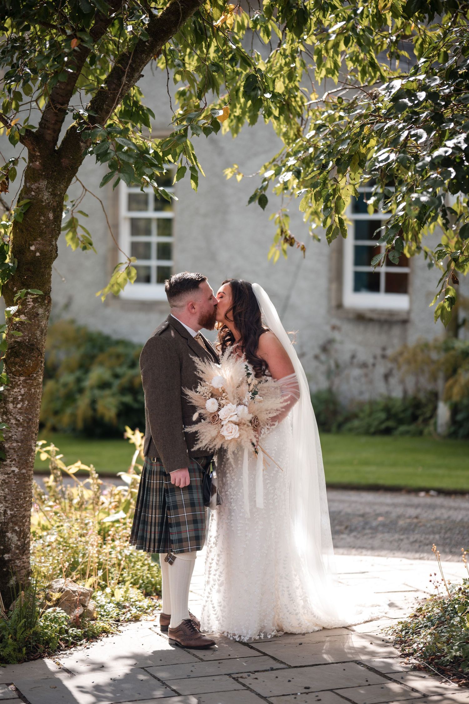 Aberdeen Wedding Photography. Sunlit garden wedding photos with traditional Scottish and bridal attire.