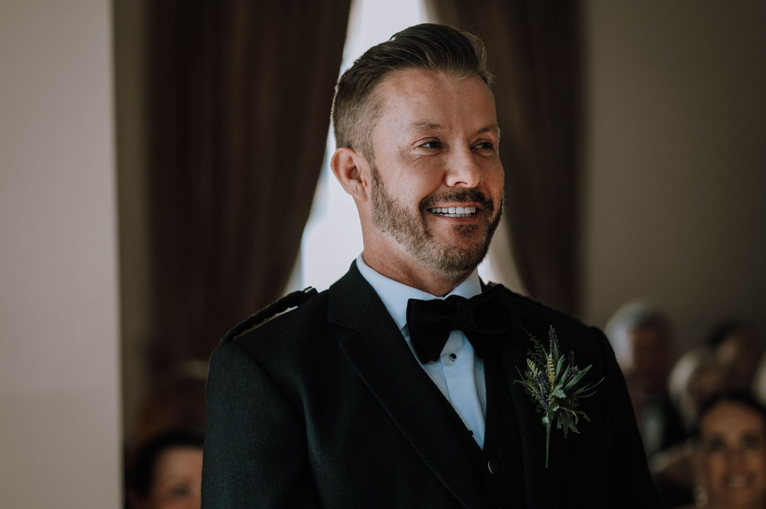 Logie House Wedding Photography. Wedding celebration candid moments captured in moody indoor lighting.