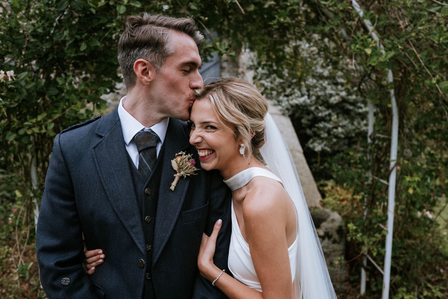 Romantic wedding portraits captured in a lush garden setting.