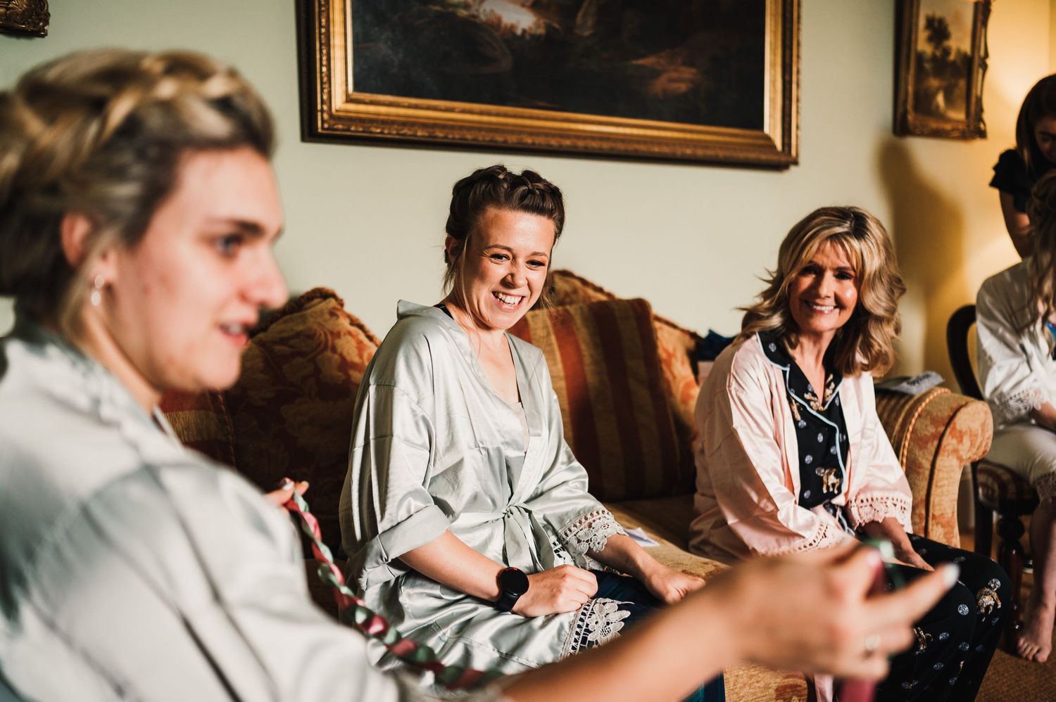A candid moment of laughter shared during wedding morning preparations.