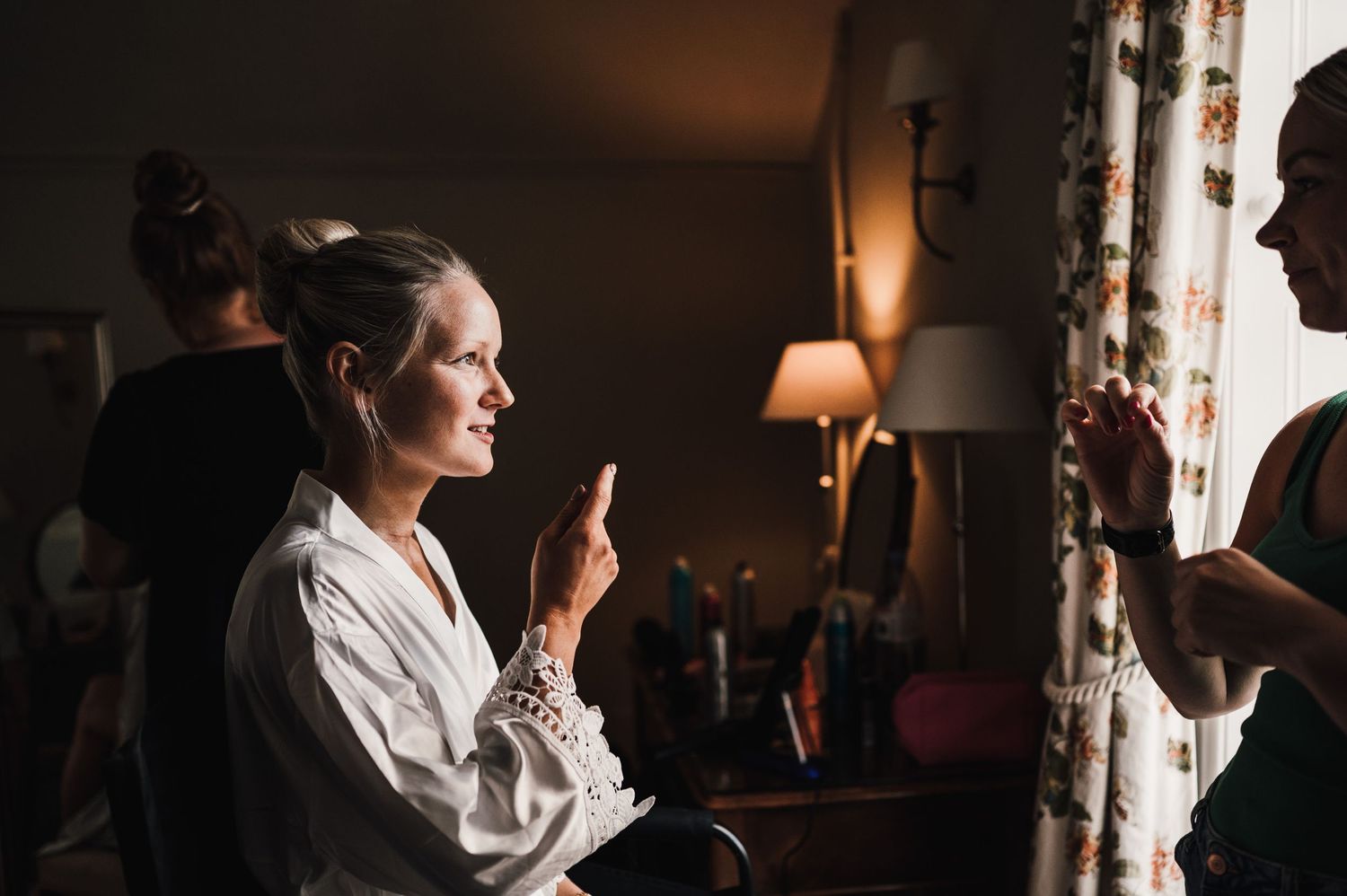 A quiet moment of preparation in a dimly lit room with warm ambient lighting.