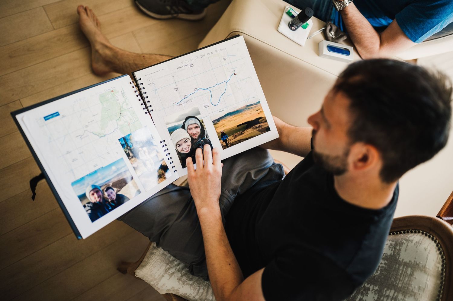 Overhead view of someone looking through a photo album or scrapbook.