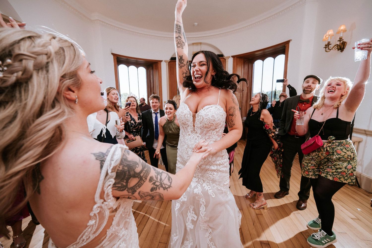 Aberdeen Wedding Photography. Wedding celebration in elegant ballroom with guests watching first dance.