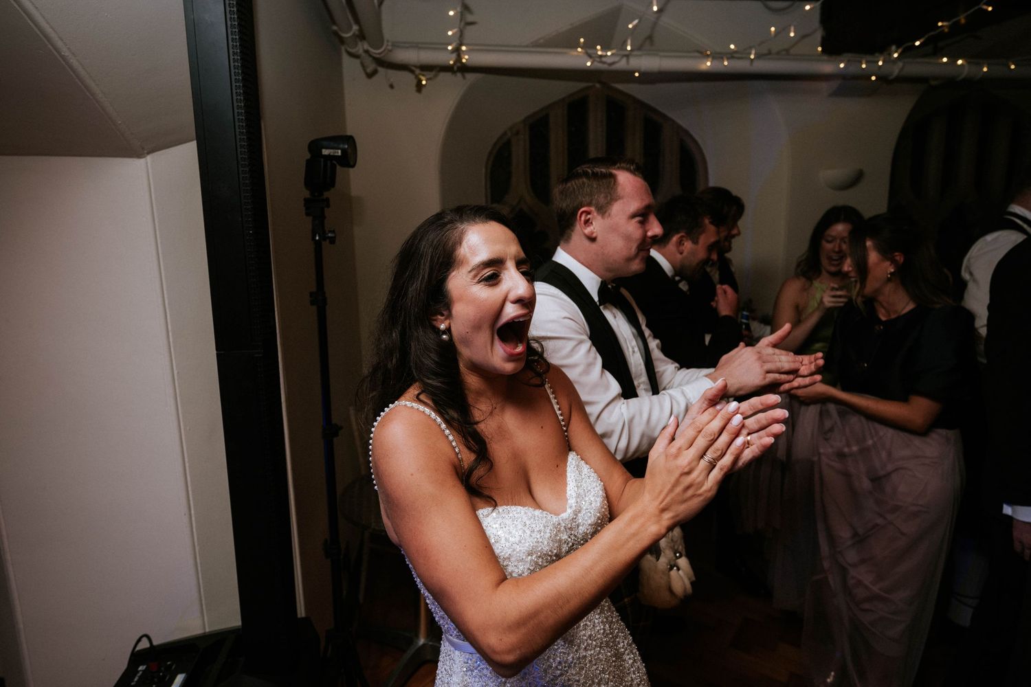 A candid moment of celebration during a wedding reception.