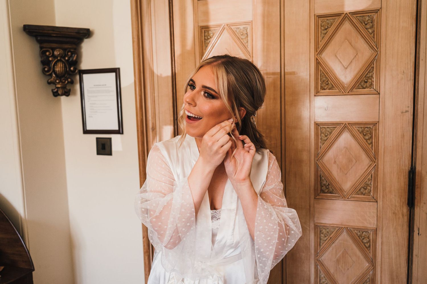 Getting ready scene in elegant room with ornate wall panels and decorative details.