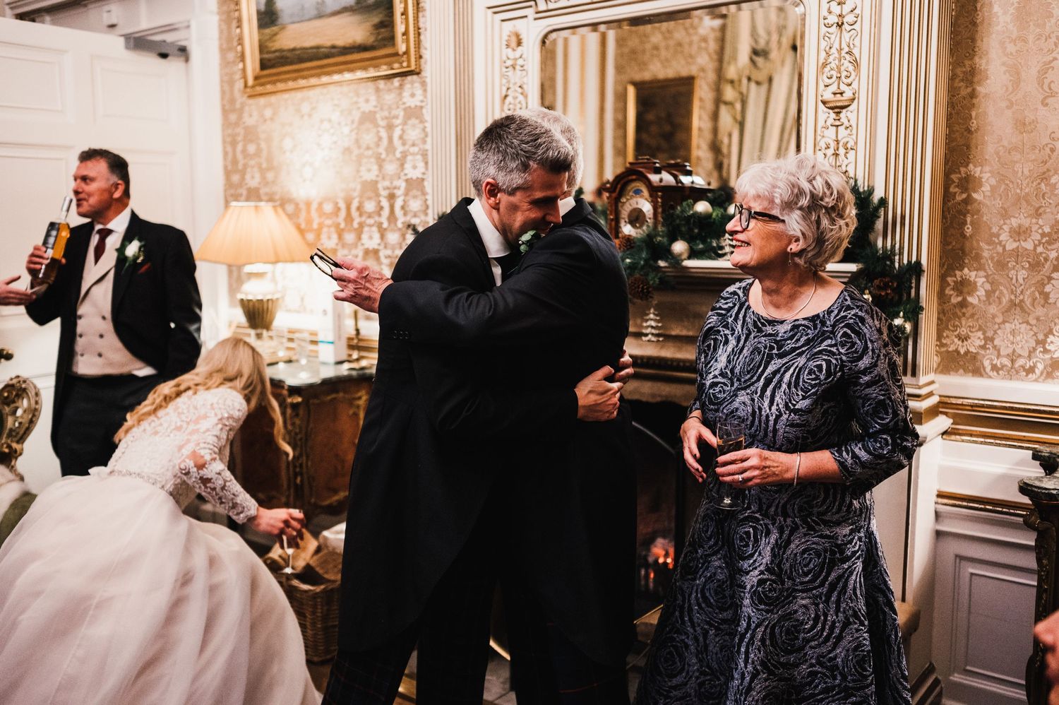 Wedding guests share a moment during celebrations in an elegant vintage-styled venue.