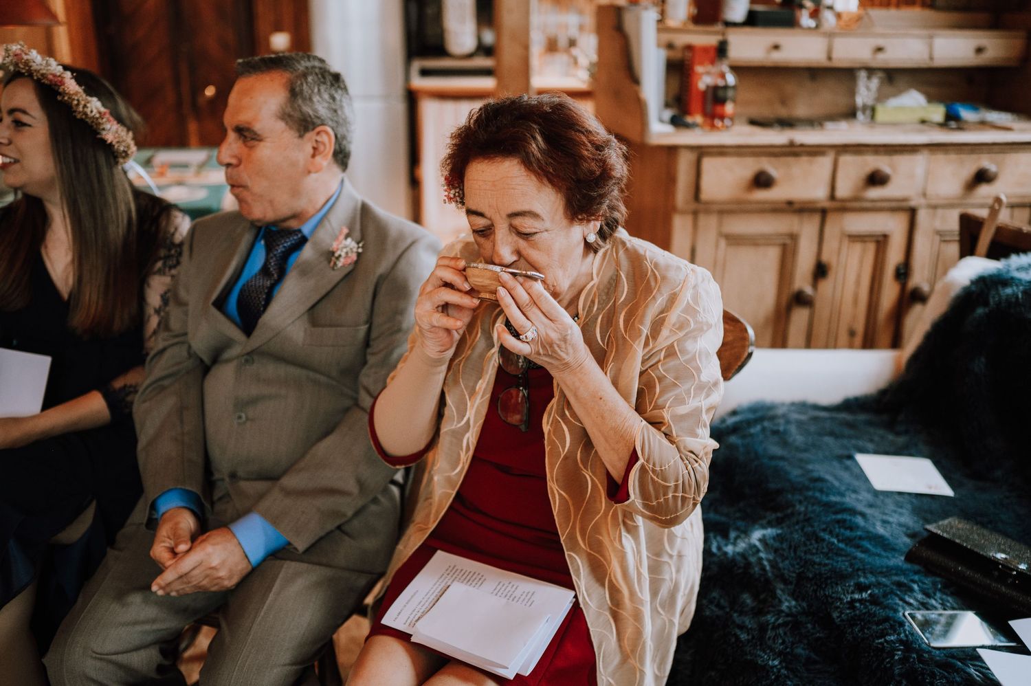 Guests share emotional reactions during what appears to be a touching moment at a wedding.