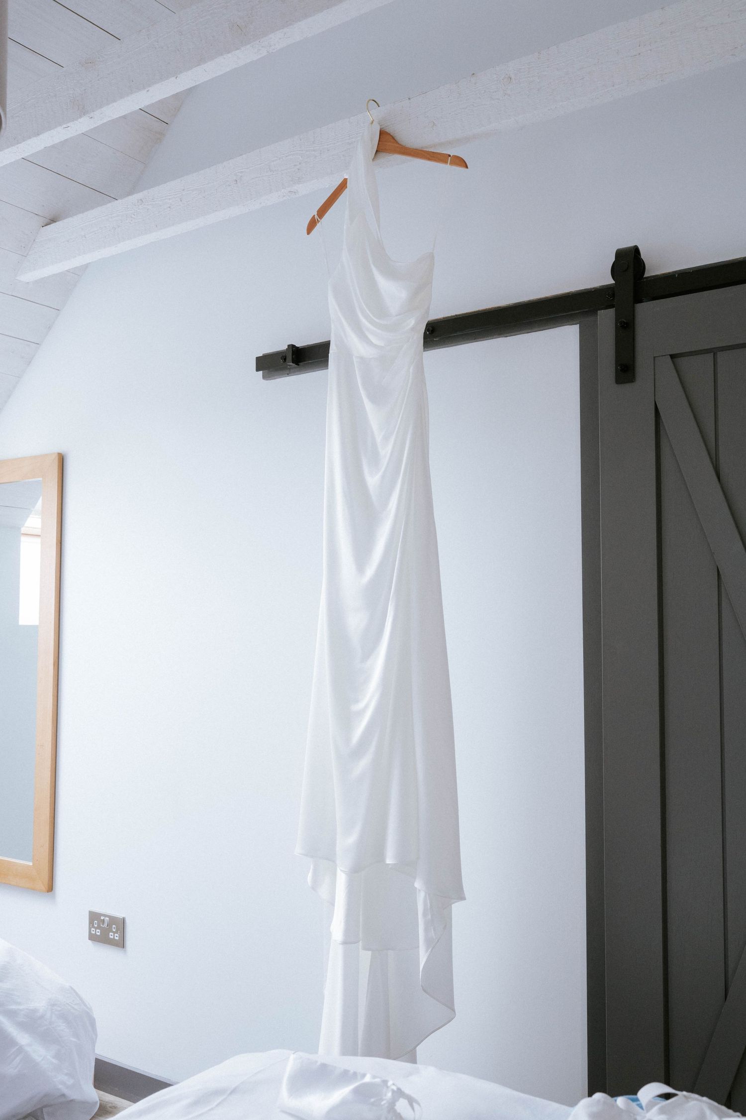 White ghost-like decorations hang from the ceiling in a minimalist white room interior.