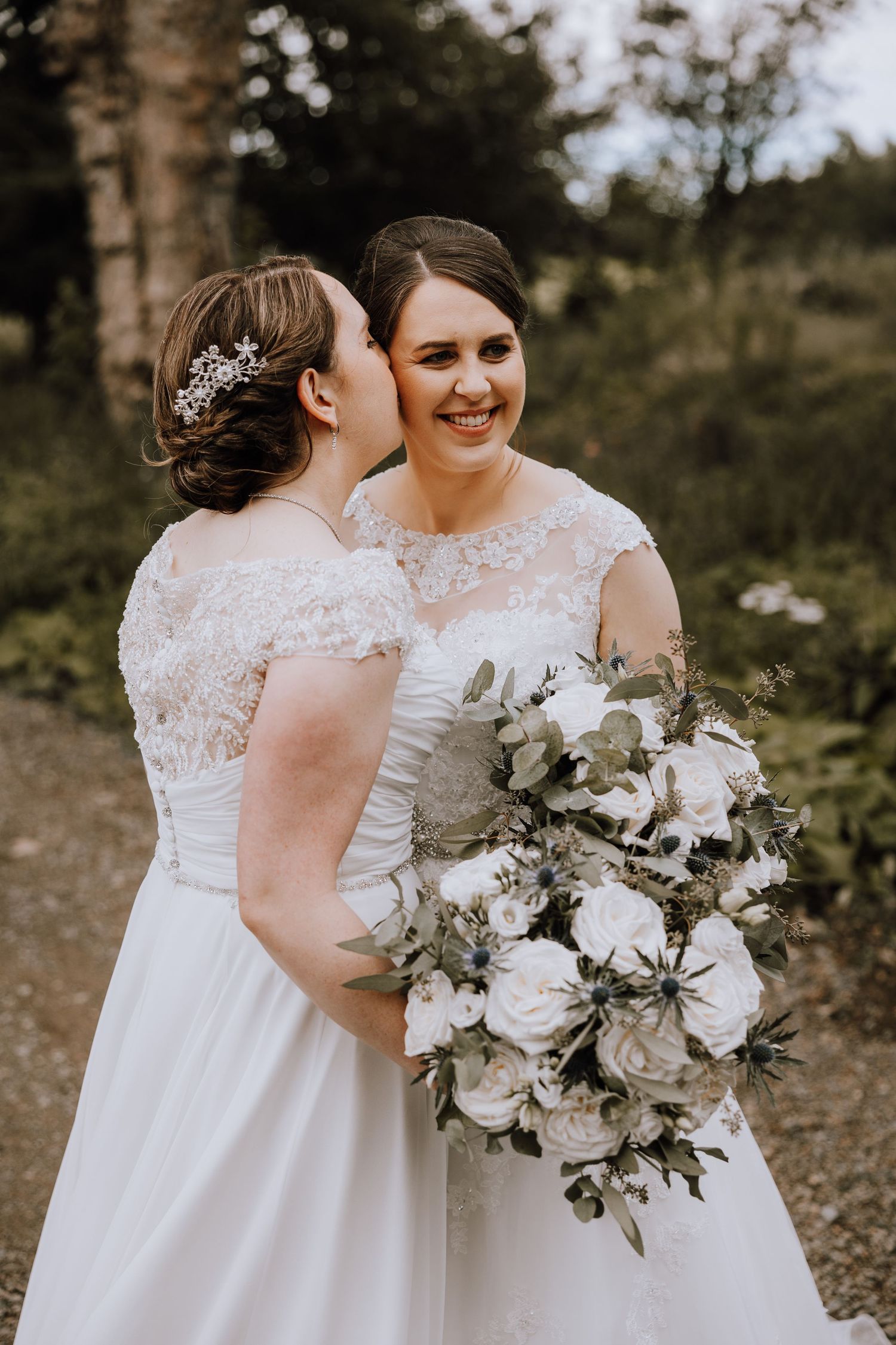 Beautiful white rose and greenery bouquets complement elegant wedding dresses. Meldrum House Wedding Photography.