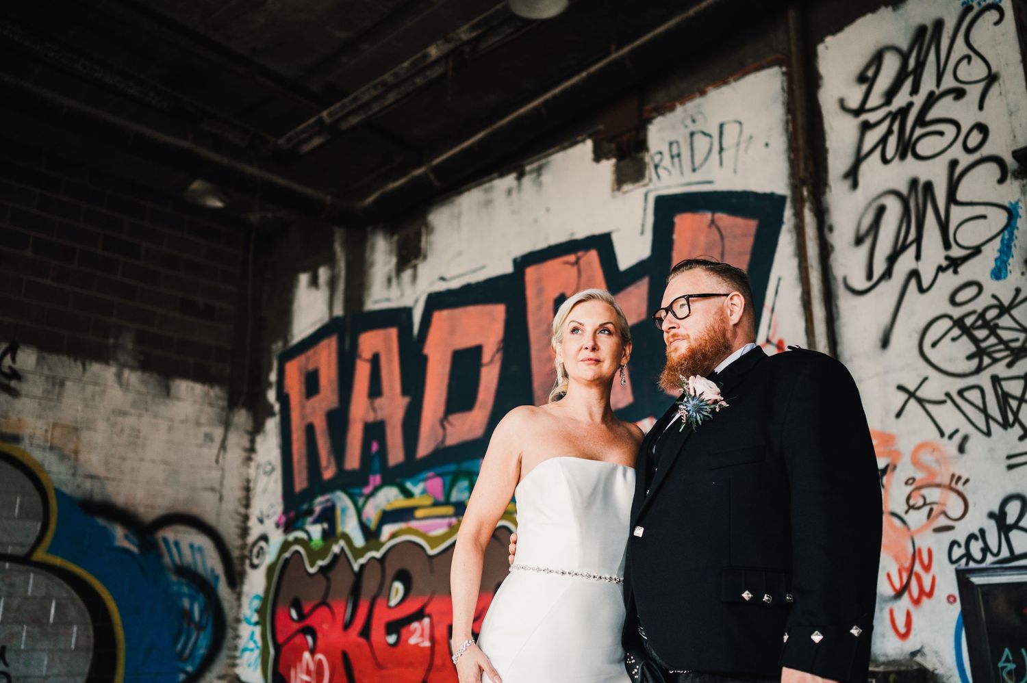 Aberdeen Wedding Photography. Wedding couple posing in front of graffiti-covered urban walls.