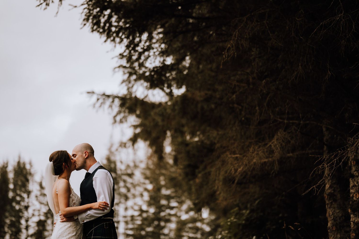 Aberdeen Wedding Photography. Romantic sunset moment in a field with trees in the background.