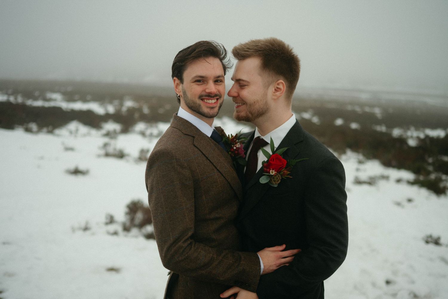 Drumtochty Castle  Wedding Photography. A couple in suits share a tender moment during their winter wedding photoshoot in the snow.
