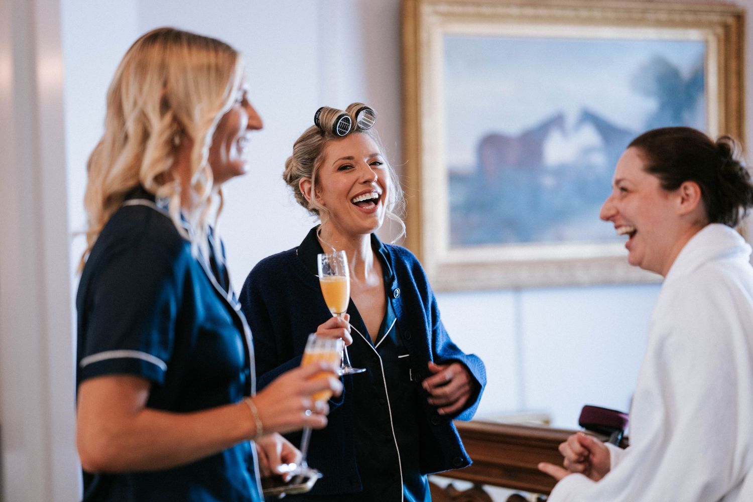 Candid moments of wedding party preparation with natural laughter.