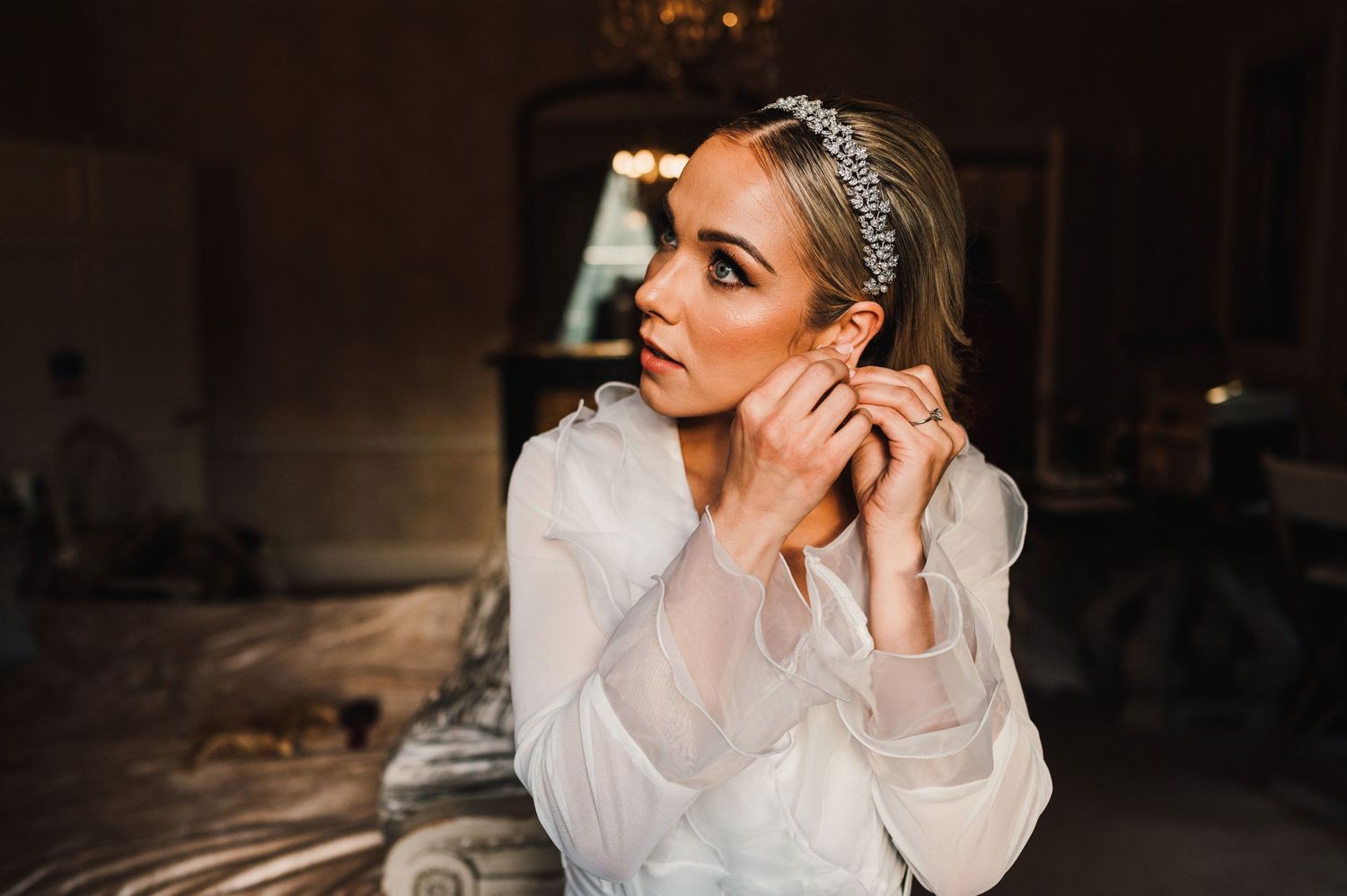 Close-up of bridal accessories and jewelry during wedding preparations.
