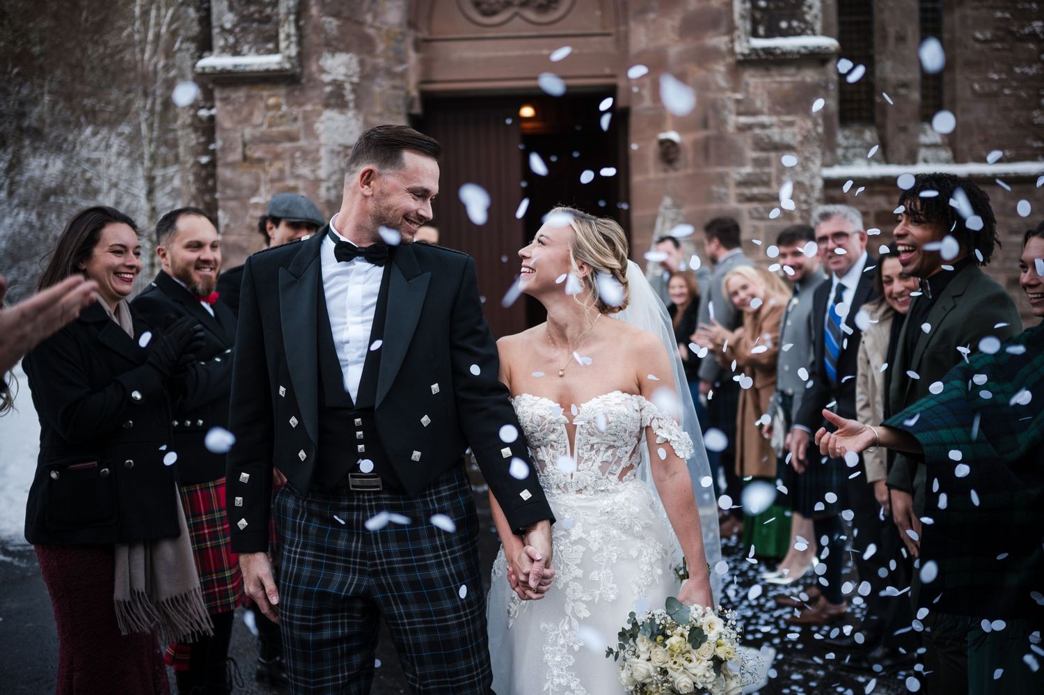 Aberdeen Wedding Photography. Wedding celebration with confetti being thrown at a brick venue entrance.
