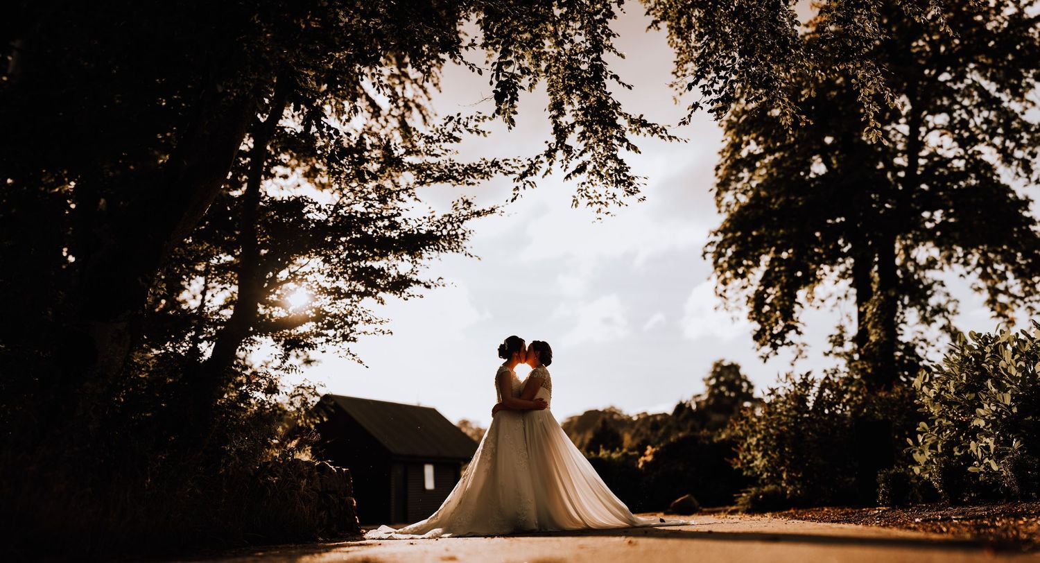 Aberdeen Wedding Photography. Silhouetted wedding couple embraces under tree branches at dusk.