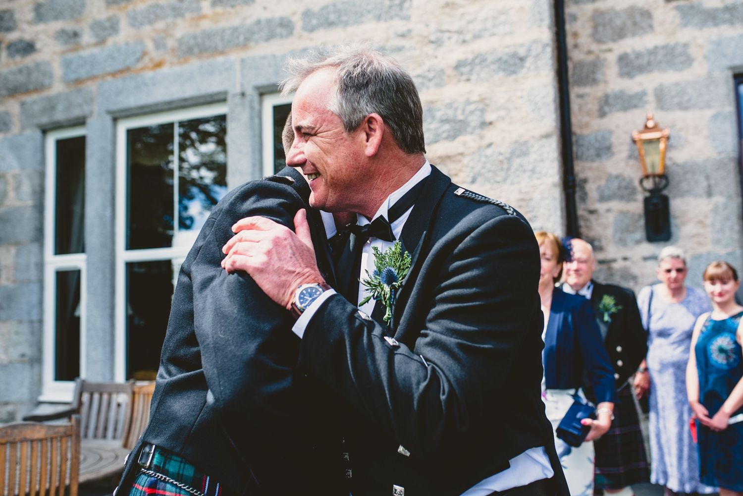 Stone building exterior provides backdrop for wedding photos.