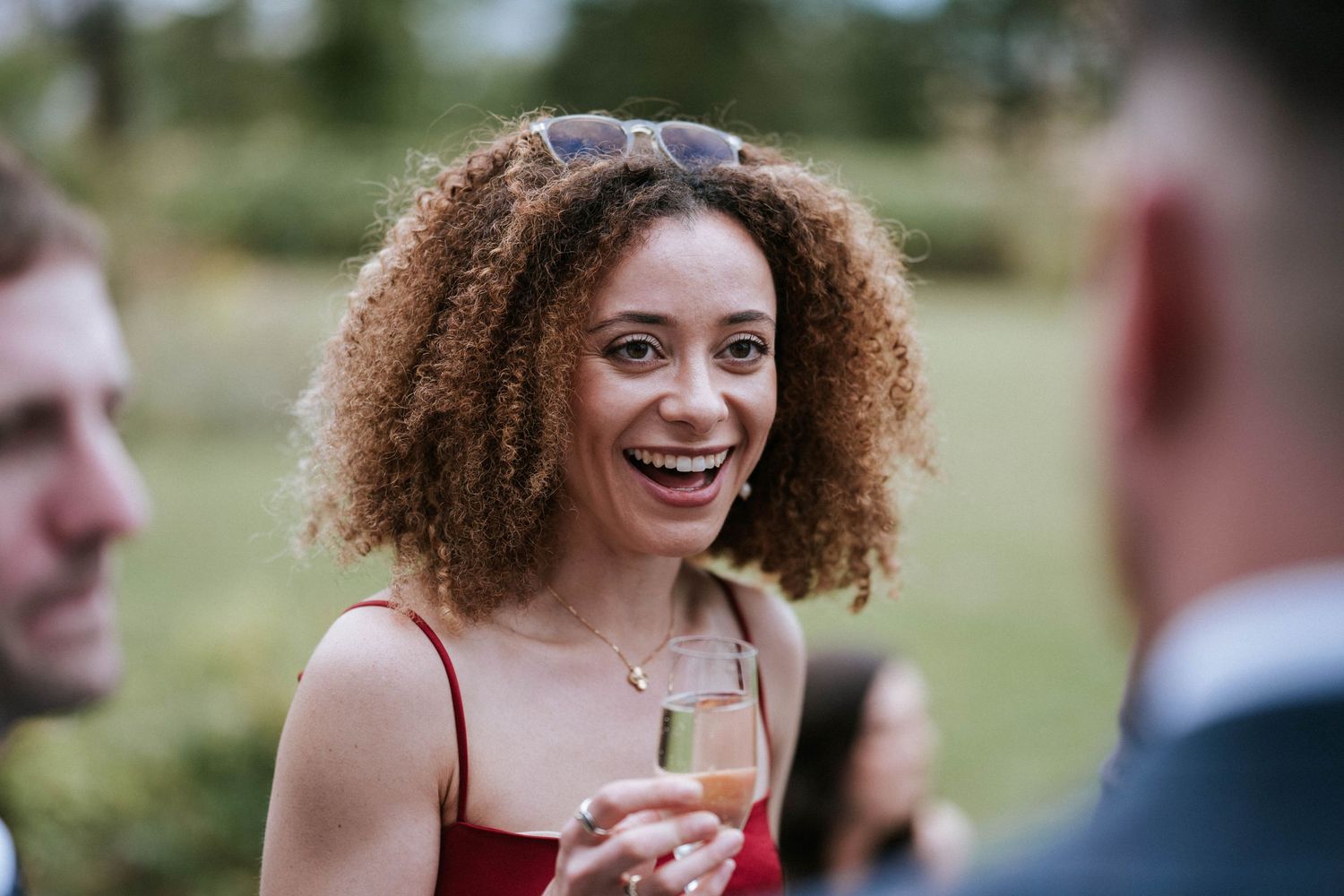 Wedding guests enjoying conversation during outdoor cocktail hour.
