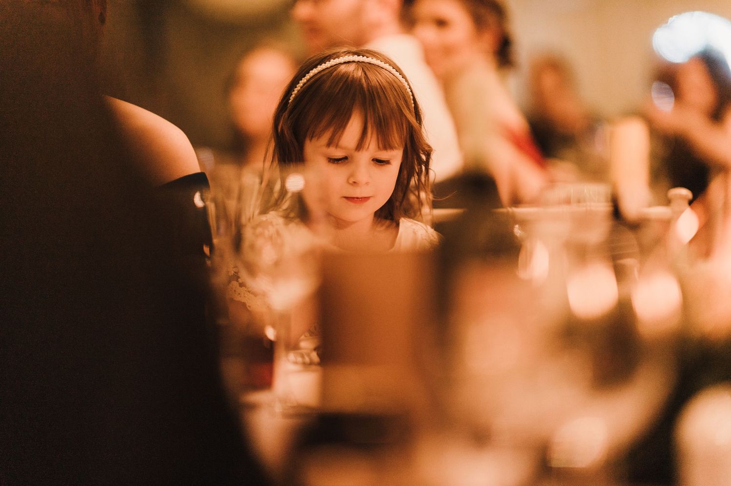 Intimate candlelit reception moment with soft focus and warm ambient lighting.