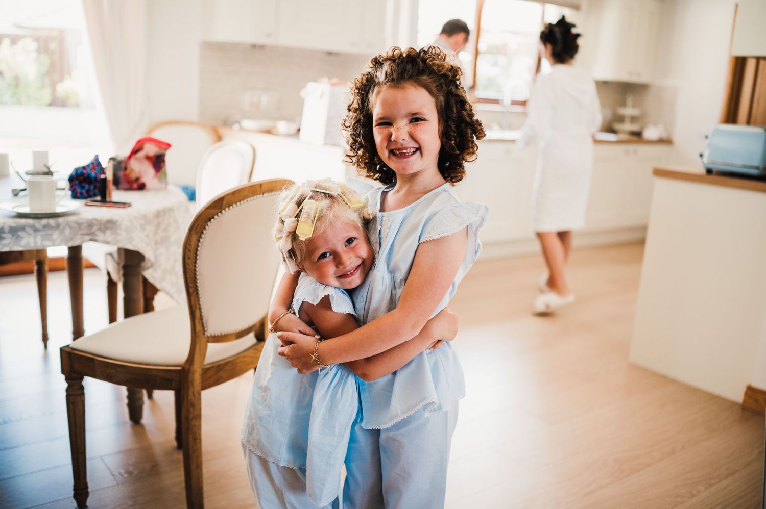 Candid wedding morning moment in a bright modern kitchen setting.
