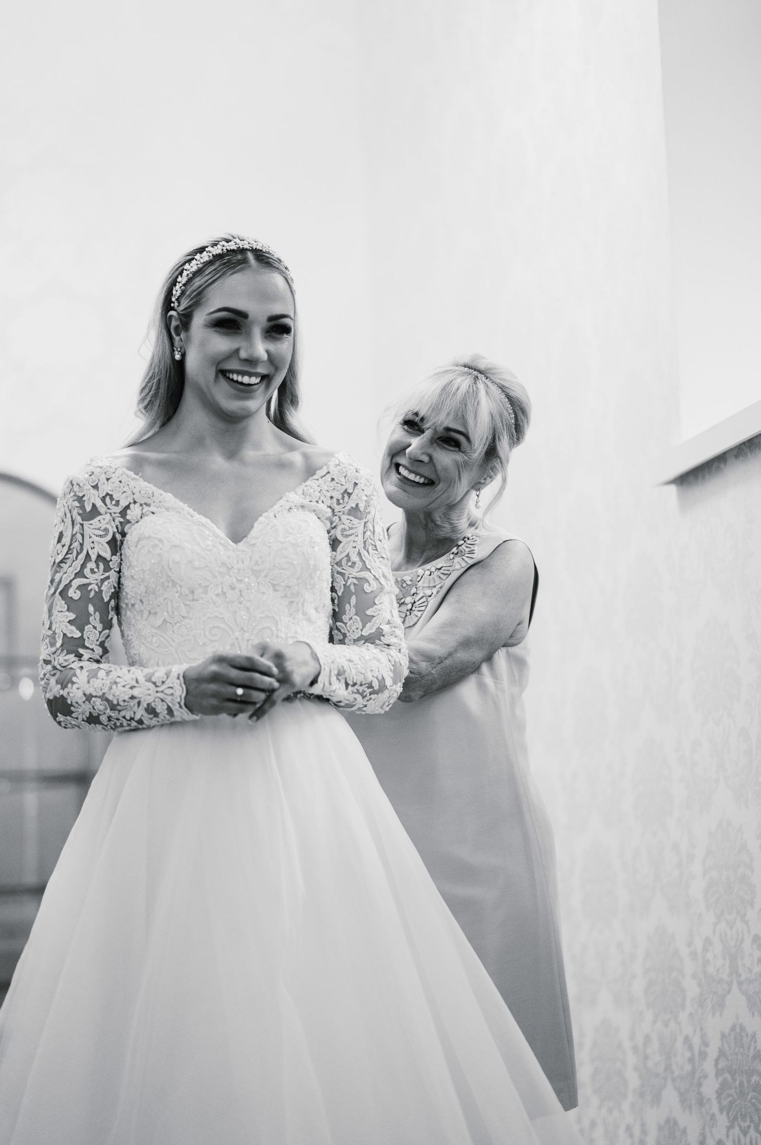 Black and white wedding preparation moment in natural light.