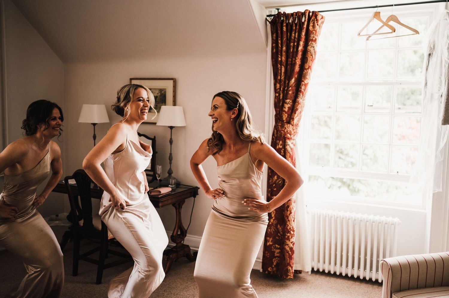Candid dancing and celebration moment during wedding morning preparations.