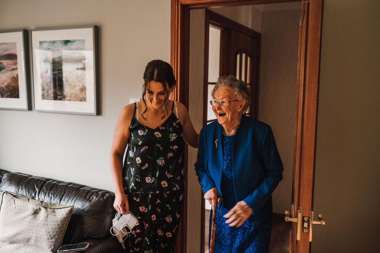 Two people sharing a joyful moment together in a living room setting.