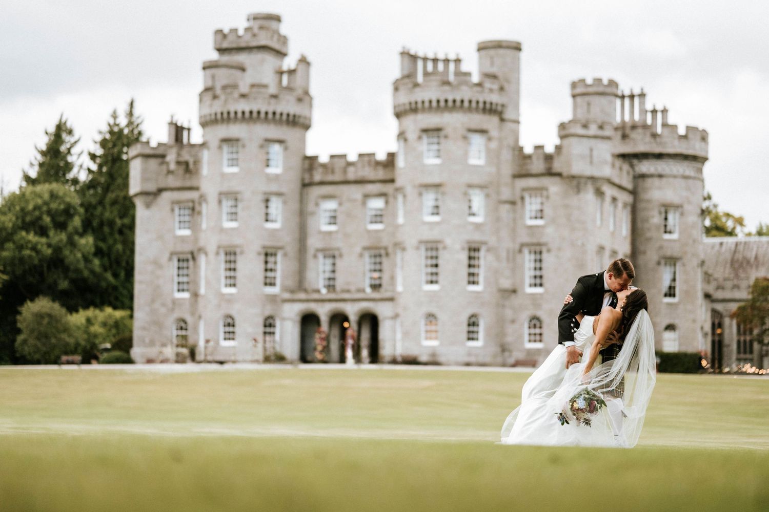 Elegant castle wedding venue with classic stone architecture and manicured grounds.