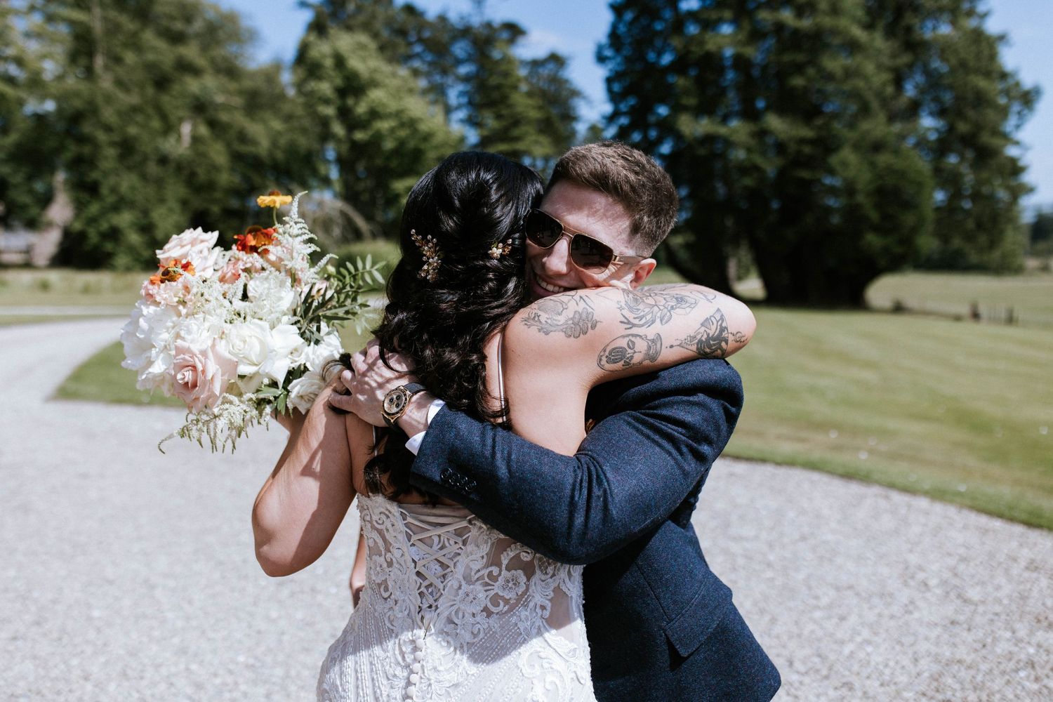 Wedding celebration candid moments captured in sunny outdoor garden setting.