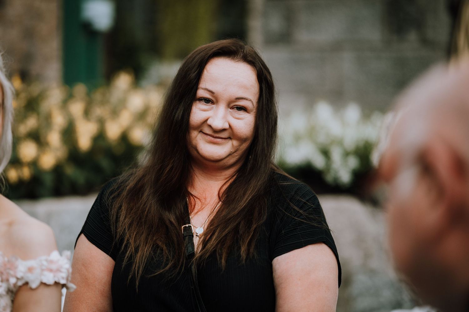 A candid smile captured during an intimate greenhouse wedding celebration.