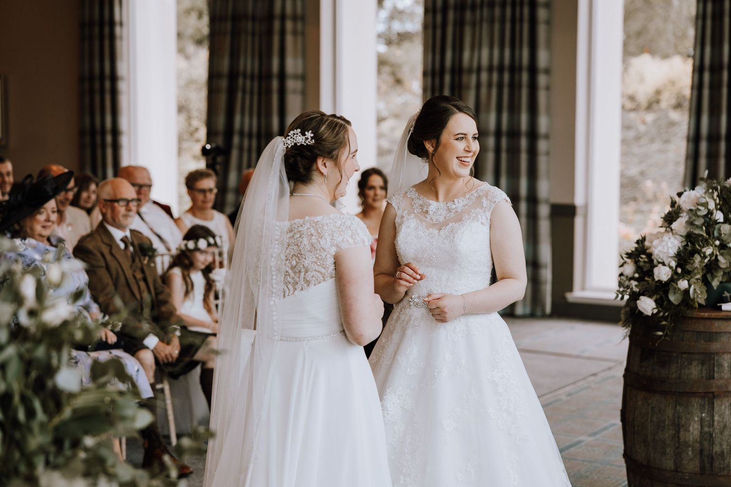 Wedding ceremony moments captured in elegant venue with dark curtains and natural light. Meldrum House Wedding Photography.