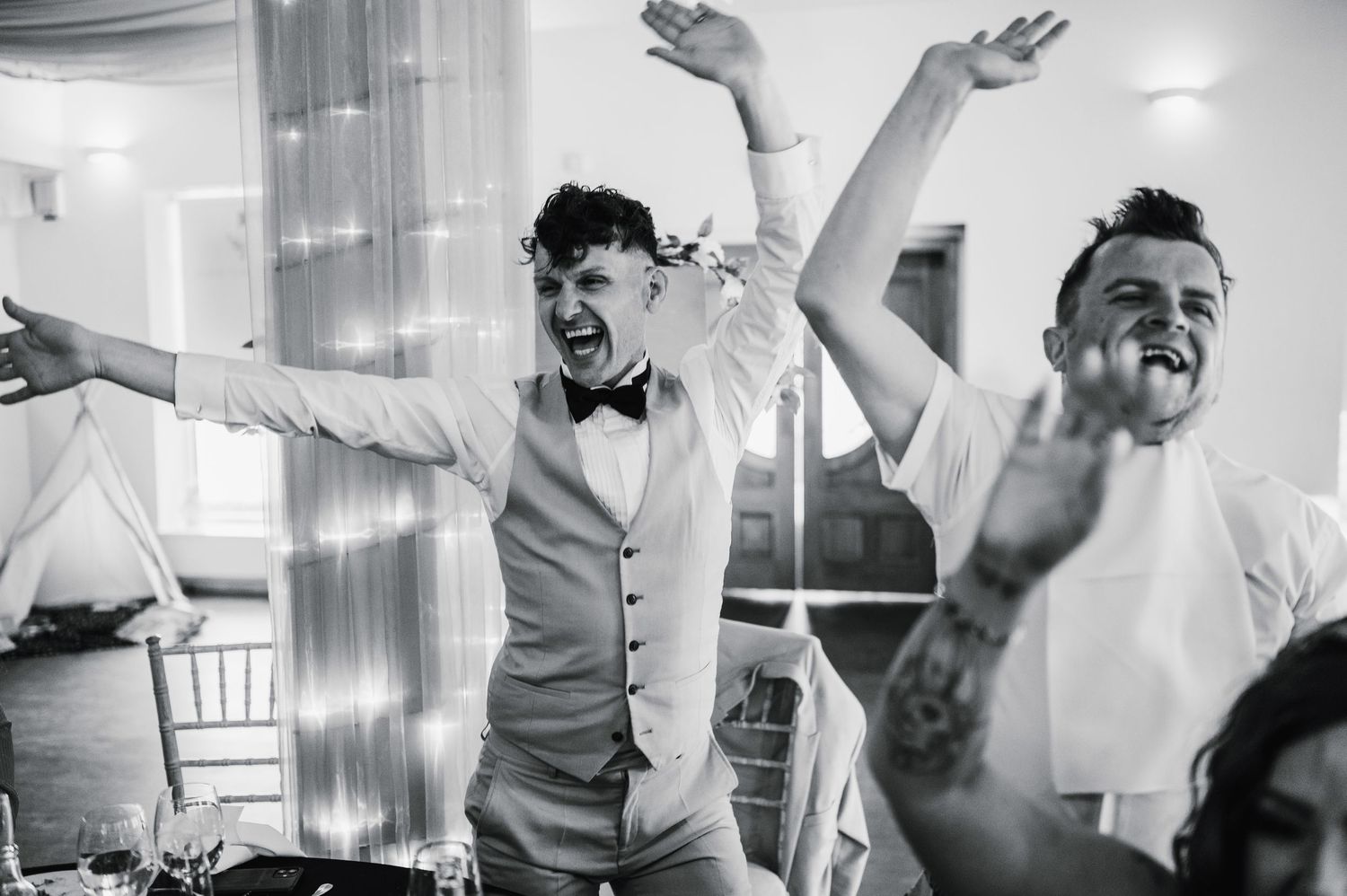 Logie House Wedding Photography. Black and white photo of energetic wedding guests dancing and celebrating.
