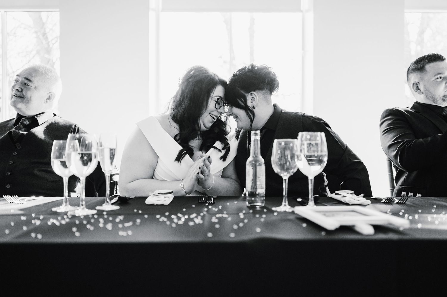 Logie House Wedding Photography. Wedding reception guests seated at head table during celebration with decorative sparkles.