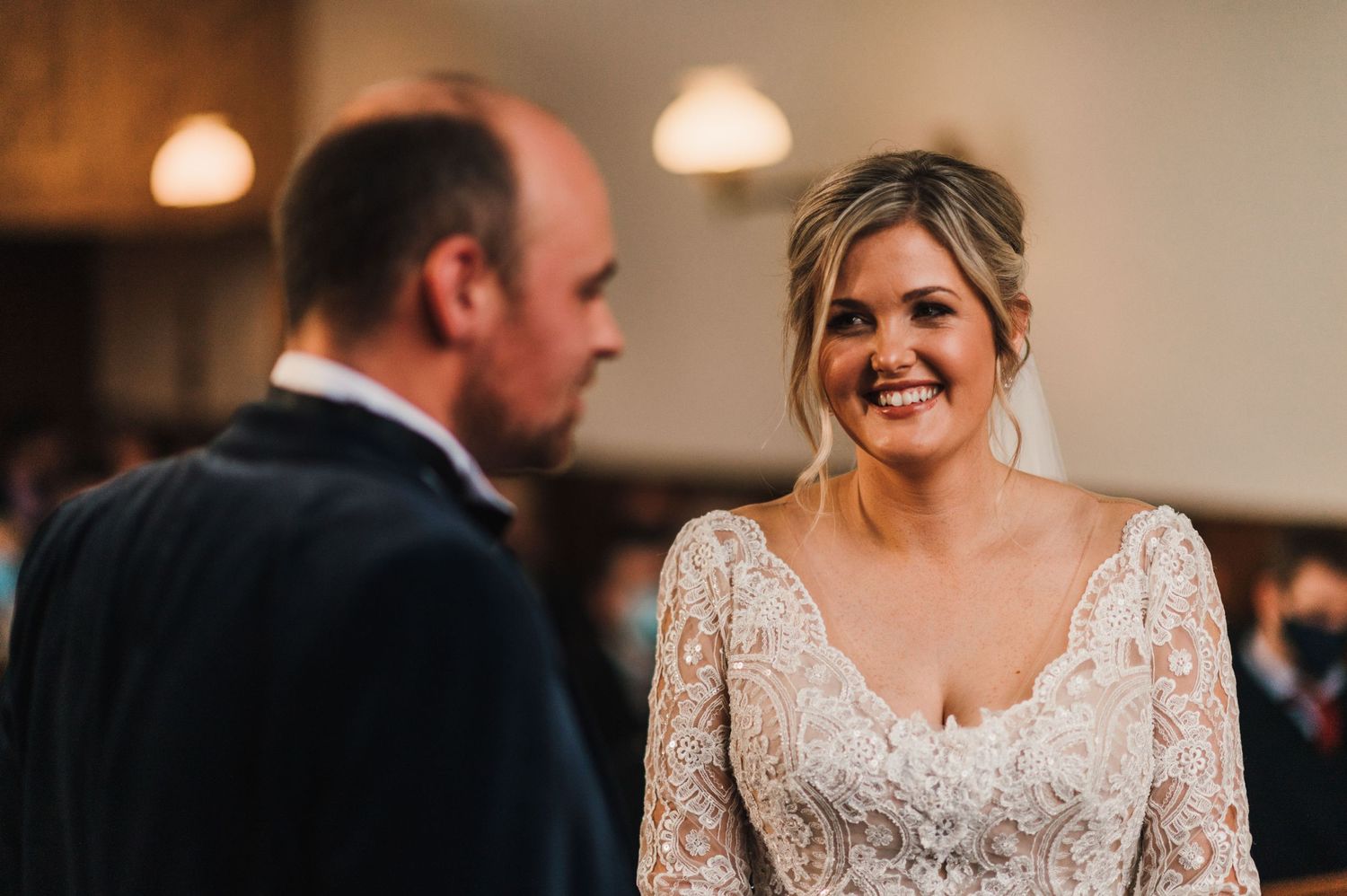 A joyful moment captured during a wedding ceremony in a church interior.