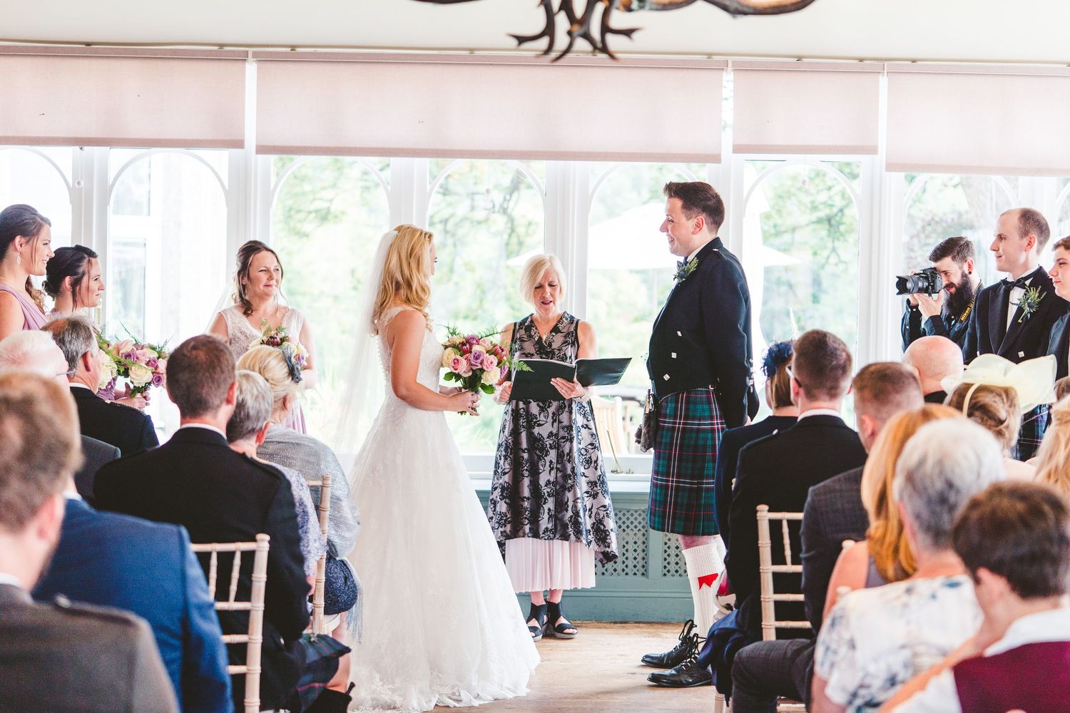 Wedding reception venue decorated with elegant table settings and floral arrangements.