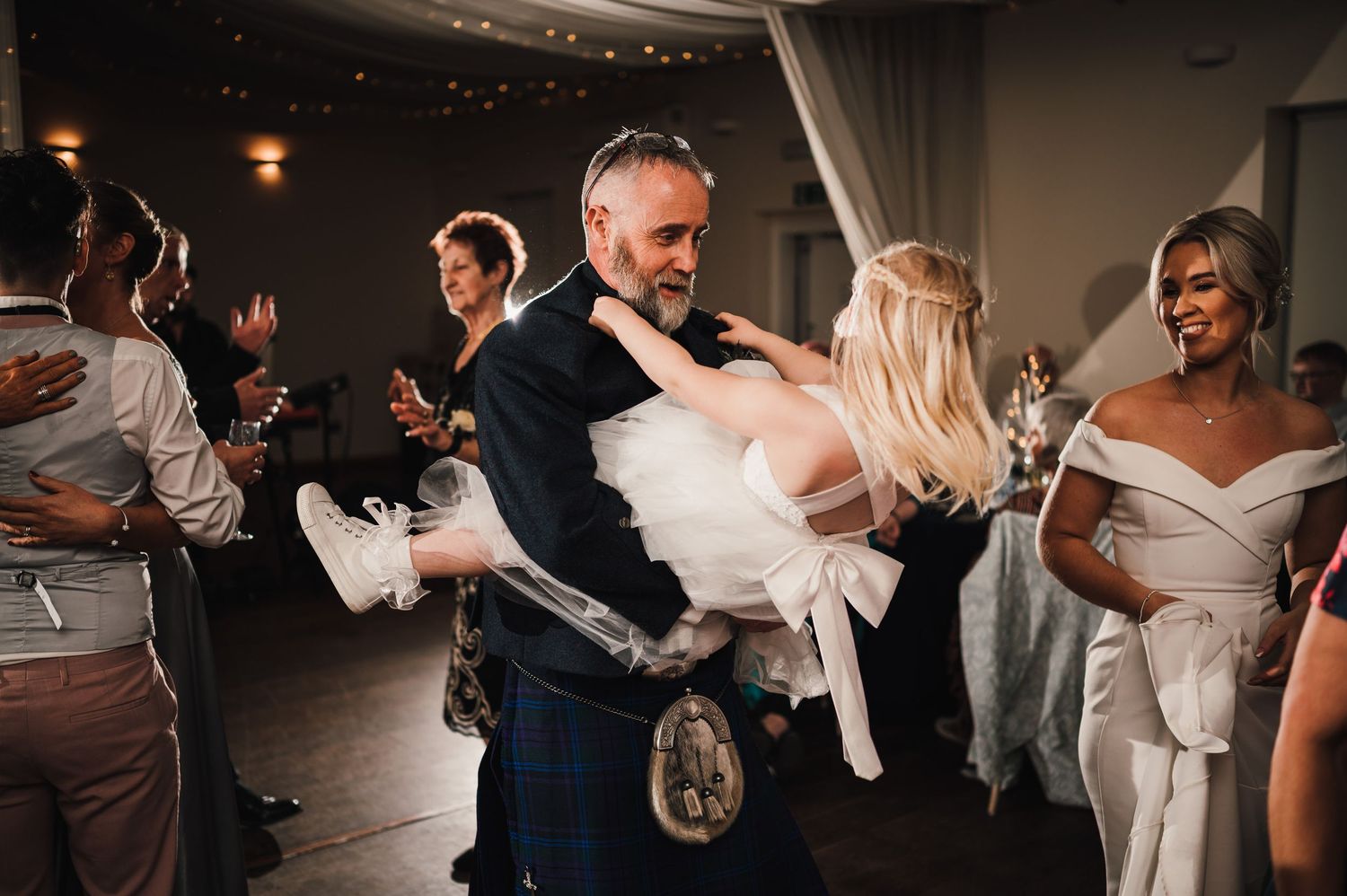 Logie House Wedding Photography. Wedding guests dancing and celebrating on the dance floor during evening reception.