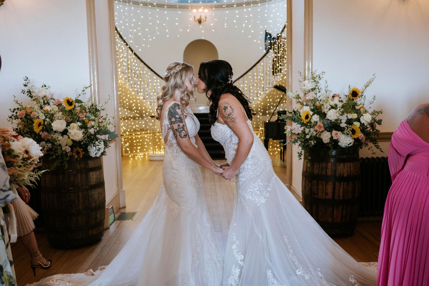 Fasque Castle Wedding Photography. Wedding ceremony space with white decor, arched doorway, and floral arrangements.
