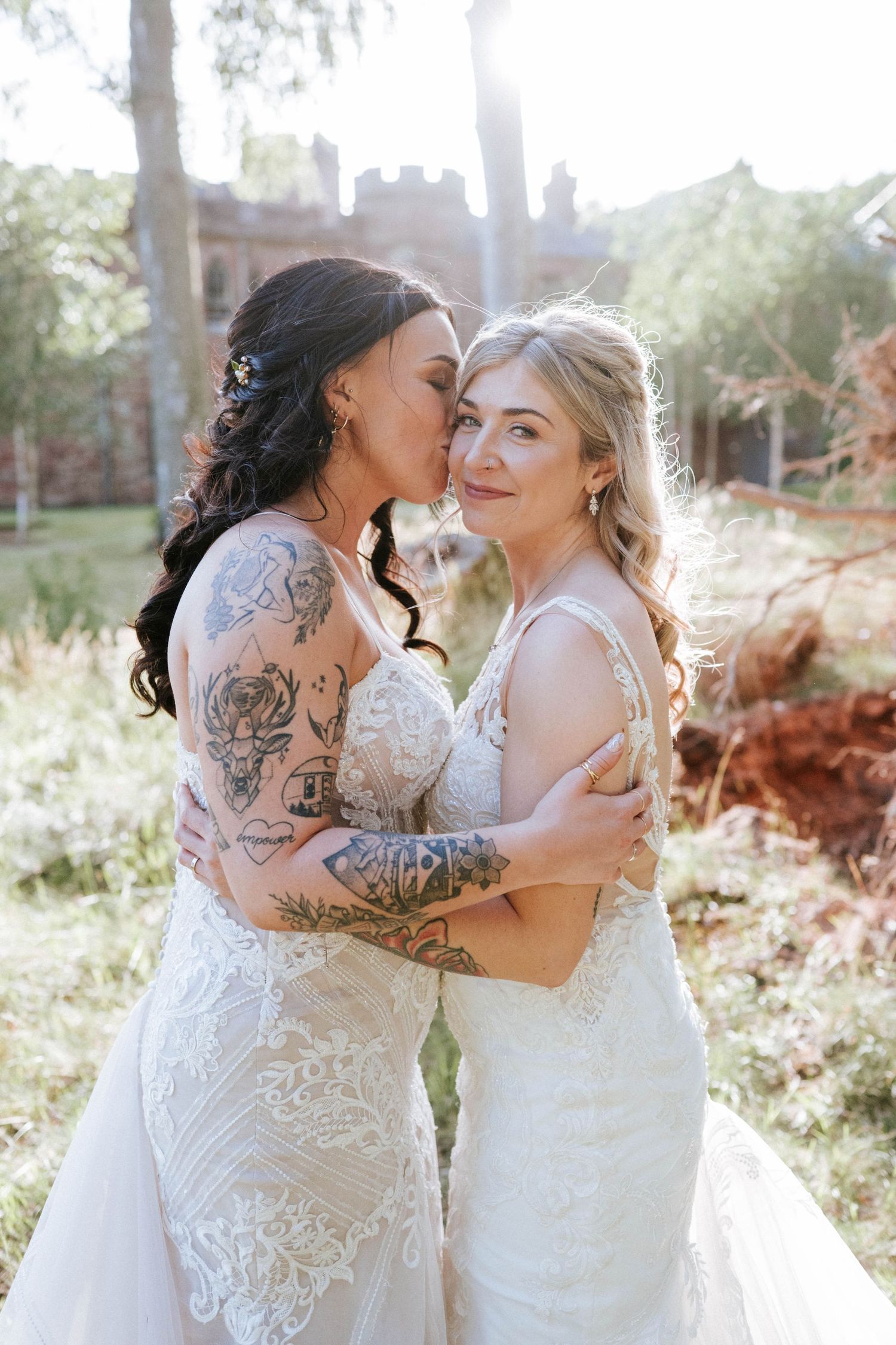 Aberdeen Wedding Photography. Intimate wedding portrait in golden sunlight with lace dresses and visible tattoos.