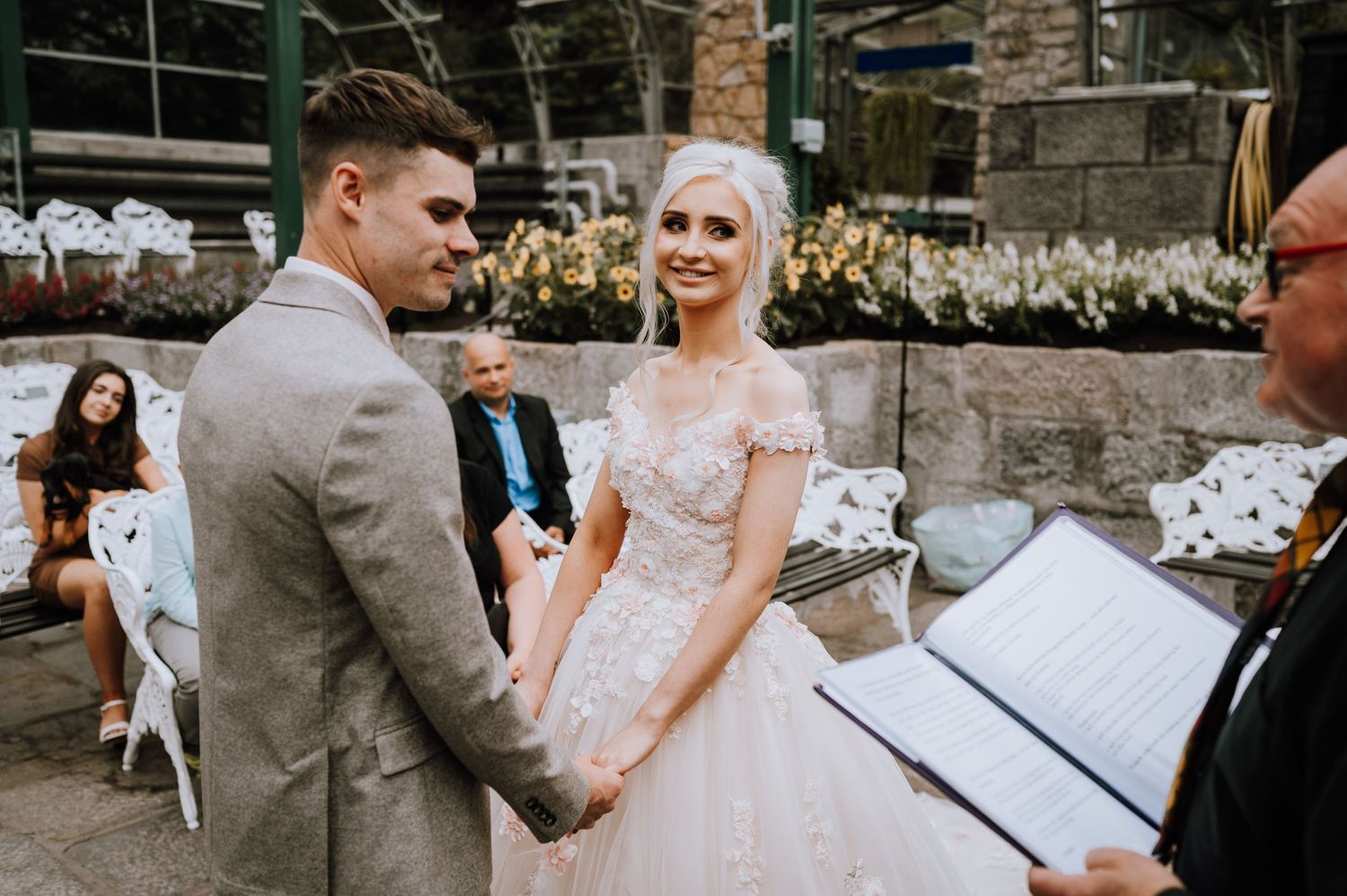 A couple exchanging vows during an intimate outdoor wedding ceremony.