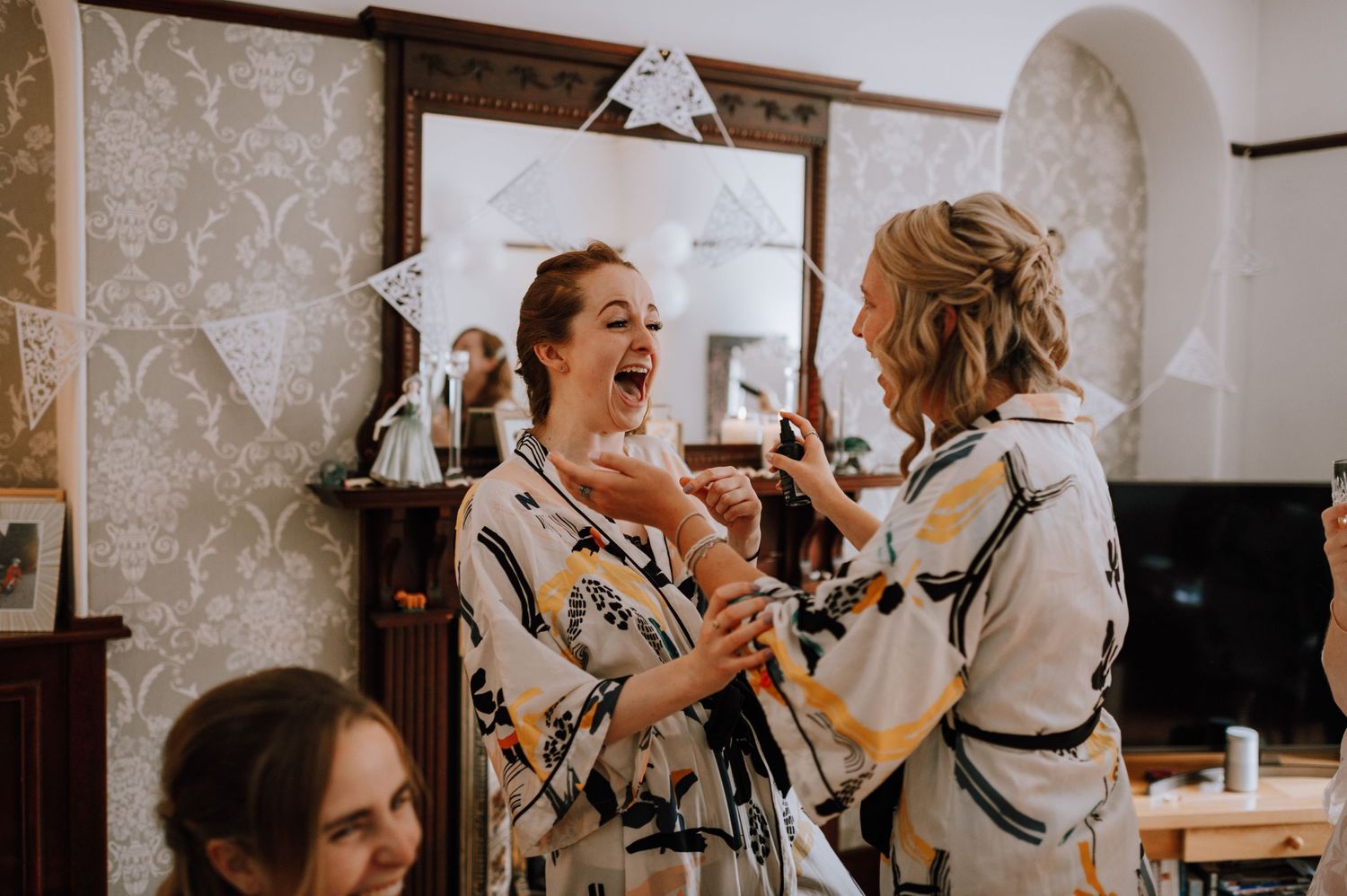 Joyful pre-wedding moment captured in a room with vintage decor.