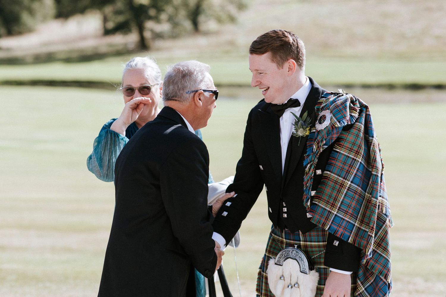 Emotional moments shared between wedding party members on castle grounds.