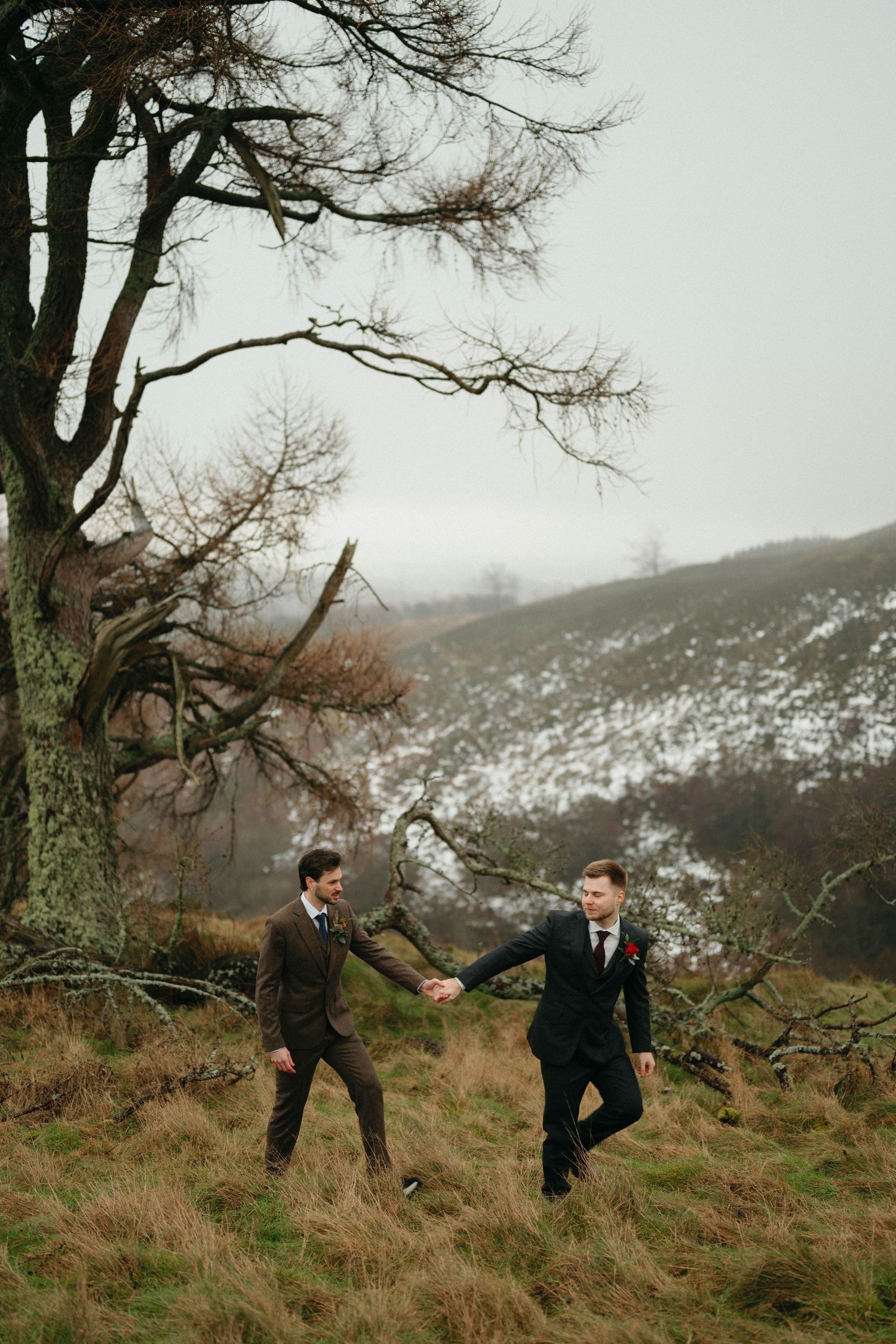 Drumtochty Castle  Wedding Photography.A romantic wedding photo session under bare winter trees with snow-covered mountains in the distance.