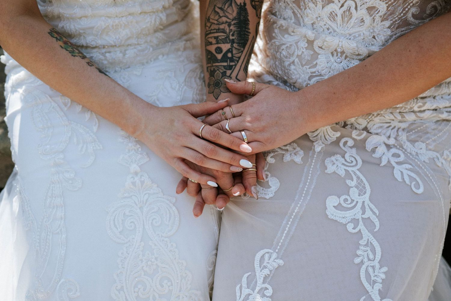 Close-up detail shots of intricate white lace wedding dress details and hands.