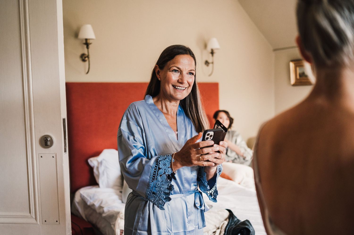 Morning preparations in a cozy bedroom with silk robes and warm lighting.
