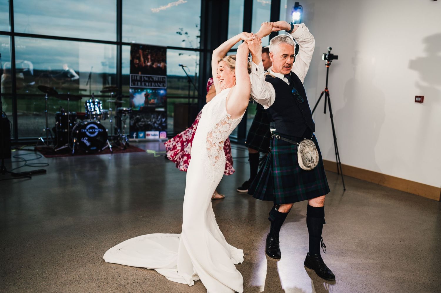 Couple performing traditional Scottish dance moves during their wedding reception.