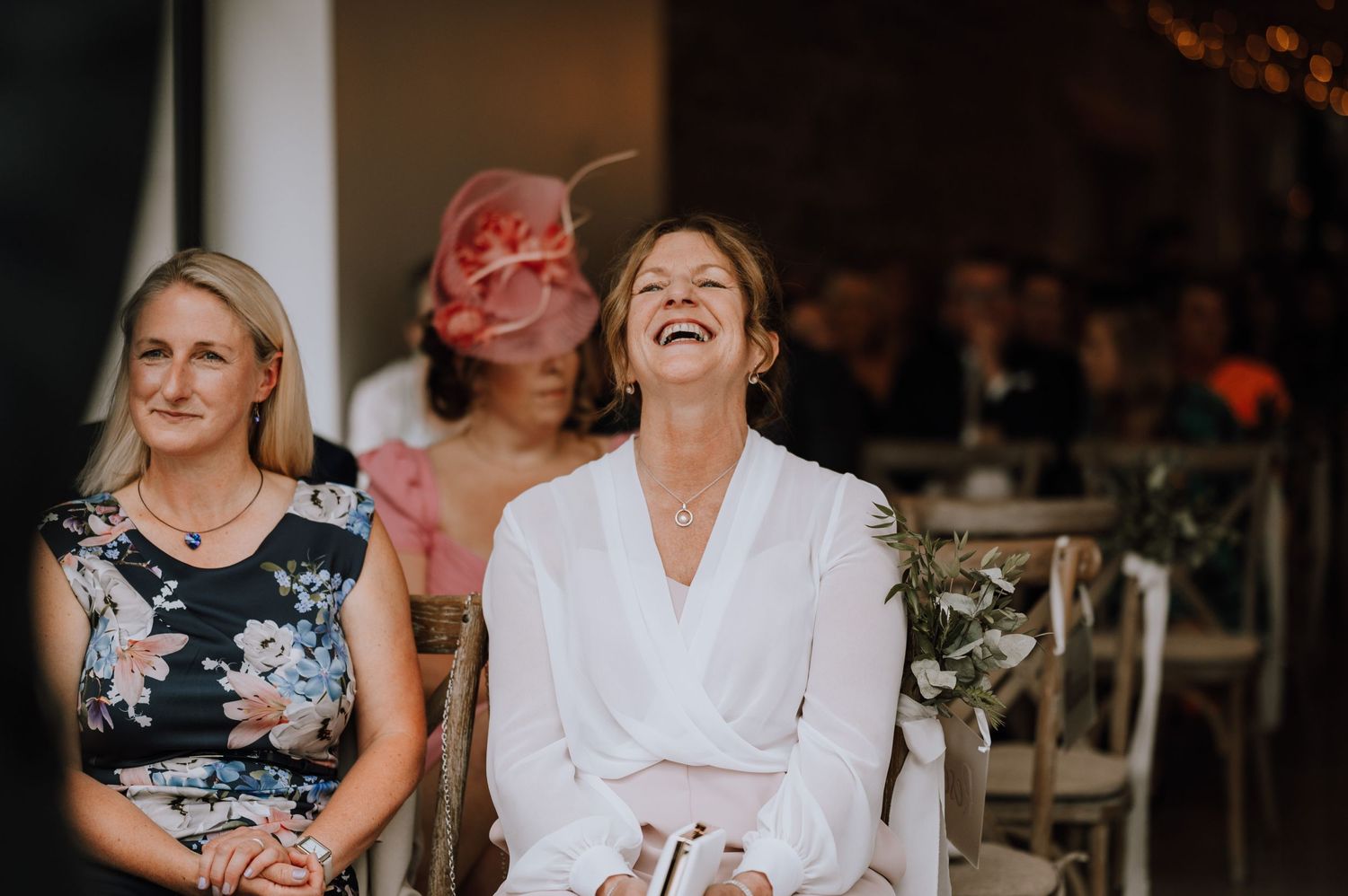 Candid moment of joyful laughter during wedding preparations.