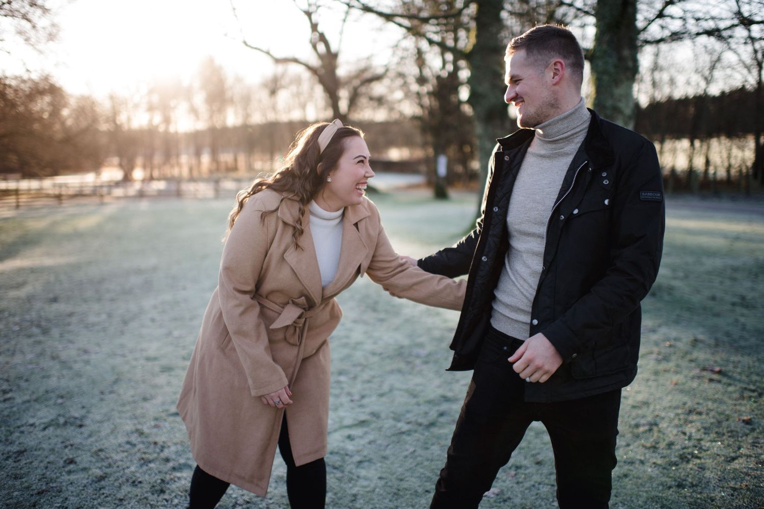 A couple shares a lighthearted moment together on a chilly winter afternoon.