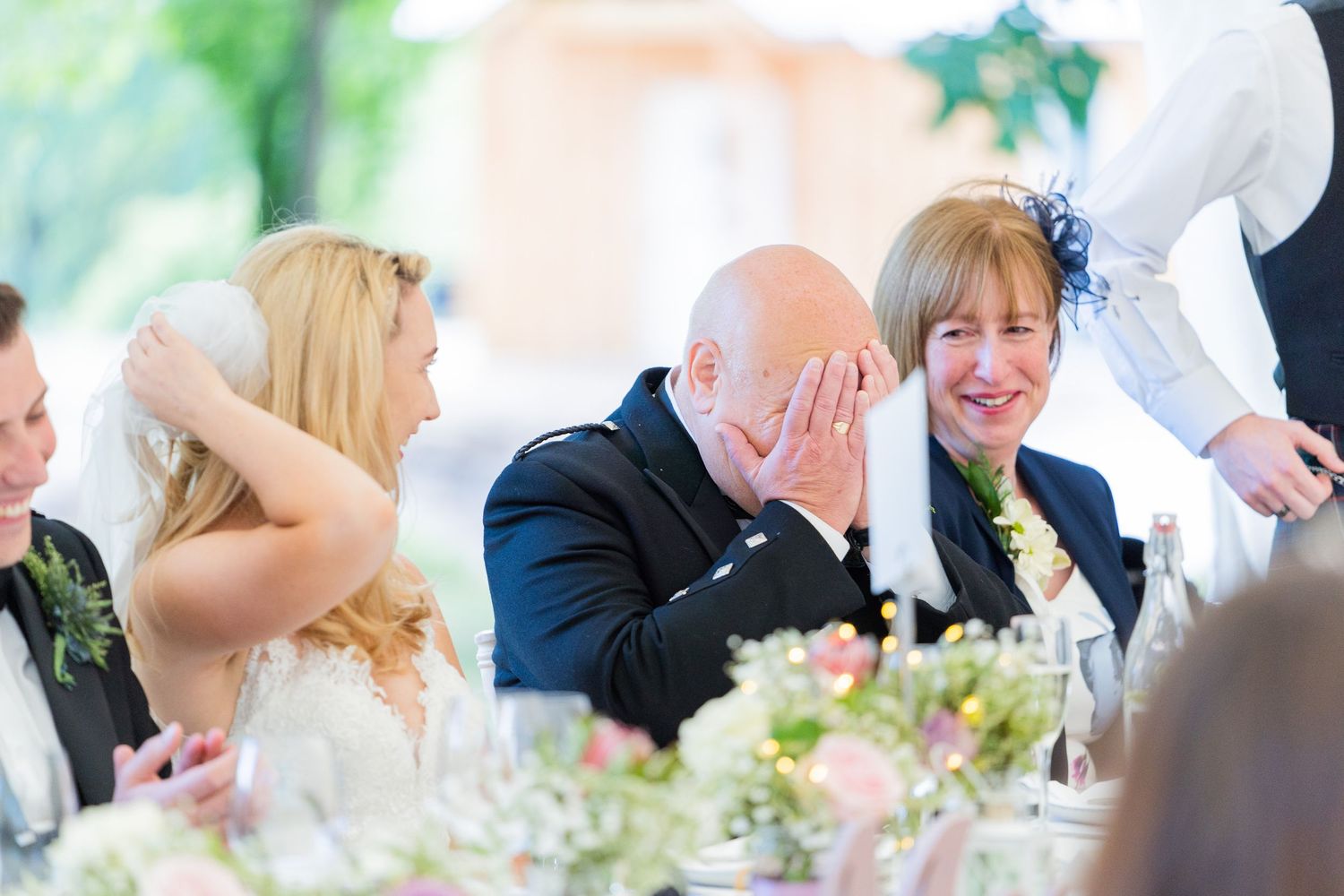 Wedding reception candid moments captured during dining celebration.