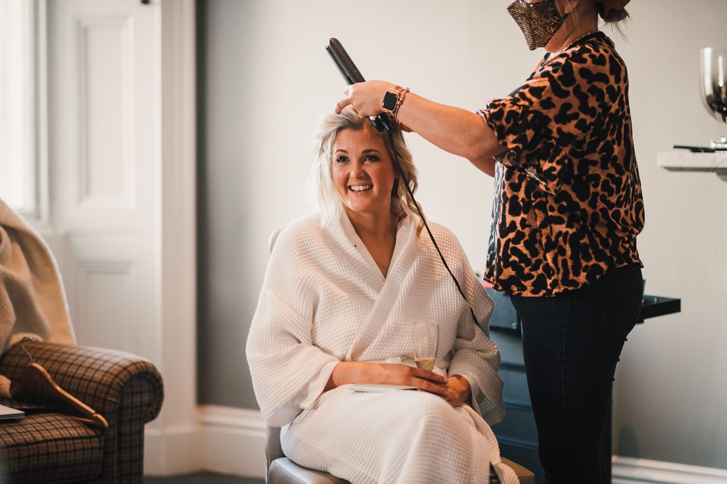Getting ready scene showing hair styling preparations in a cozy room setting.